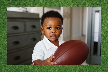 toddler holding football