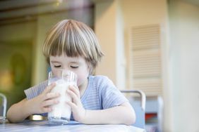 Child drinking a glass of milk