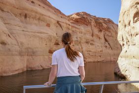 Woman looks out over the water in Antelope Canyon / Lake Powell