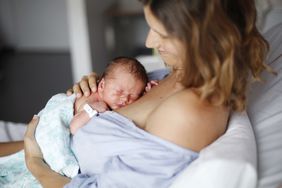 A newborn and their mother at maternity ward