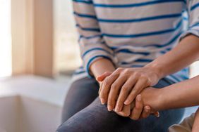 An image of a woman holding another woman's hands.