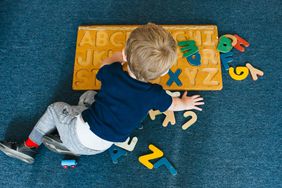 An image of a boy doing a puzzle.