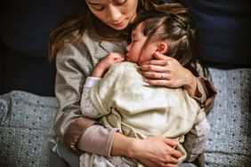 An image of a mom cuddling with her daughter.