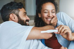 An image of a couple with a pregnancy test.