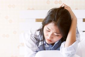 Depressed woman crying on her bed