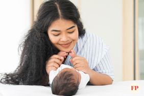 Mother looking down at newborn baby