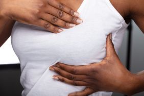 Close-up Of A Woman's Hand On Breast After Pregnancy