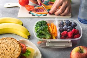 An image of a mother making a school lunch.