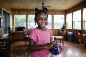 Young black girl smiling and looking into the camera 