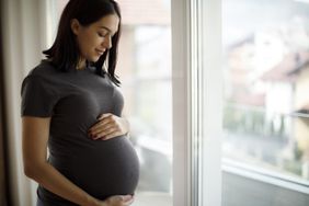 woman holding her pregnant belly