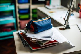 An image of a stack of books on a desk.