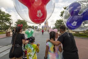 An image of a family going into Walt Disney World.