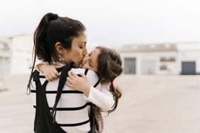 An image of a mom hugging her daughter.