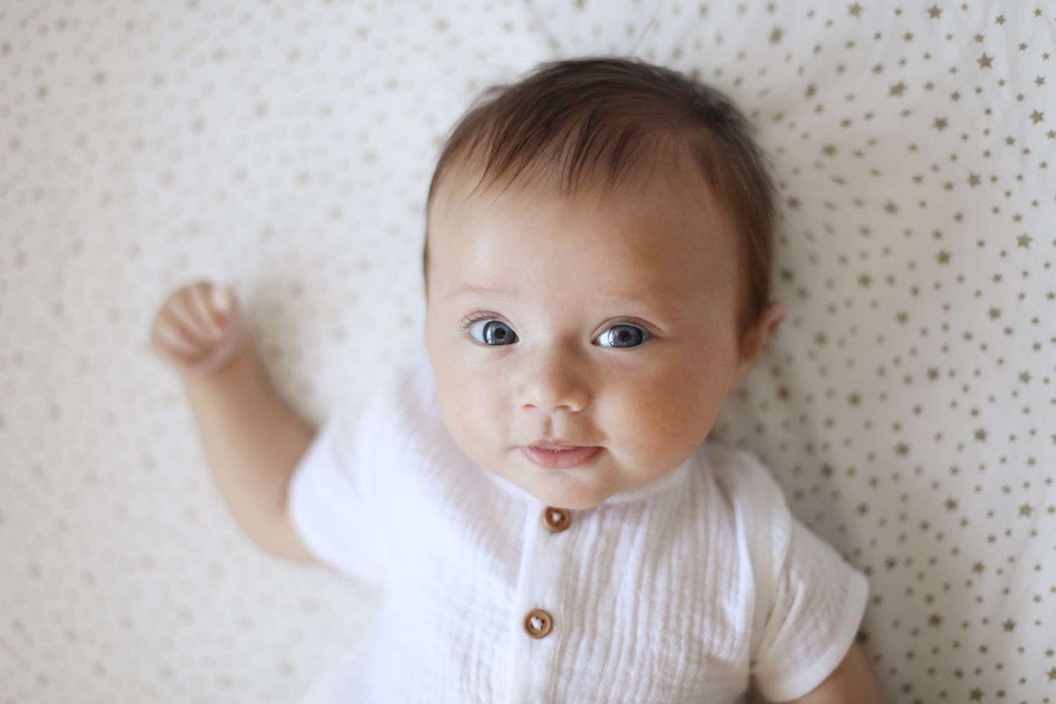 baby girl with blue eyes on a blanket