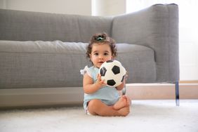 baby holding a soccer ball