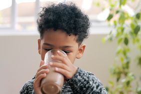 young boy drinking chocolate milk