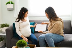 pregnant person and doula holding a calendar