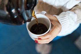 woman pouring coffee into mug