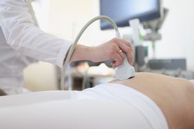 Ultrasound scanner device in hand of professional doctor examining patient