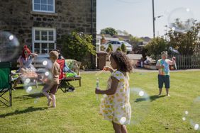 Children playing with bubble wands outside