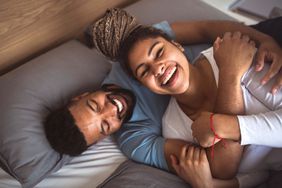 couple laughing in bed