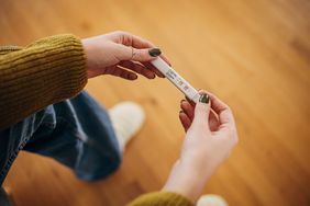 person's hand holding pregnancy test