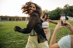 Teen girls dancing in a park 