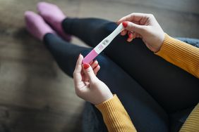 woman holding a positive pregnancy test