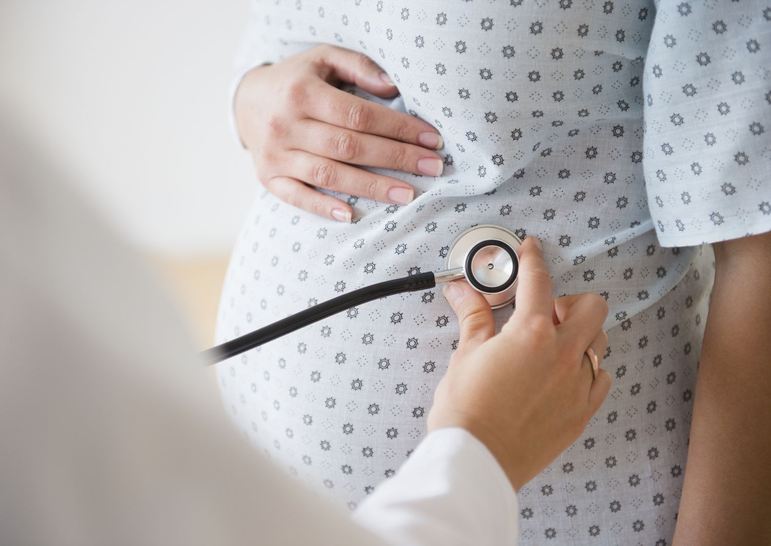 Doctor examining pregnant person