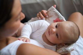 Close-up shot of Newborn Baby Girl Looking at Her Mother