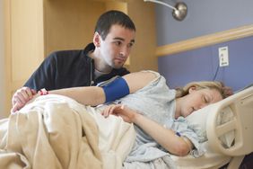 Man helping a woman in childbirth