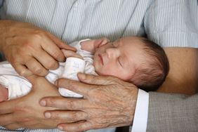 Sleeping baby being held