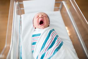 new born baby crying in hospital basinet