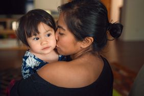 mom kissing toddler on the cheek.