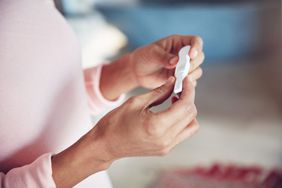 An image of a woman looking at a pregnancy test.