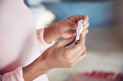 An image of a woman looking at a pregnancy test.