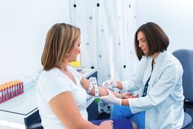 Nurse taking blood sample Nurse getting blood from on a female donor