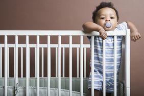 baby boy standing in a cot