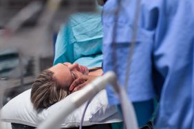 A Doula comforts a pregnant woman moments before her caesarean section