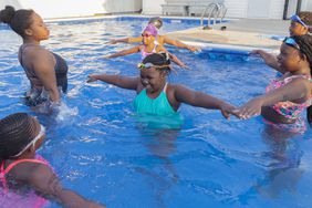 Black Children in pool with at swim class