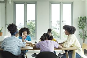 School children are studying at home with a teacher.