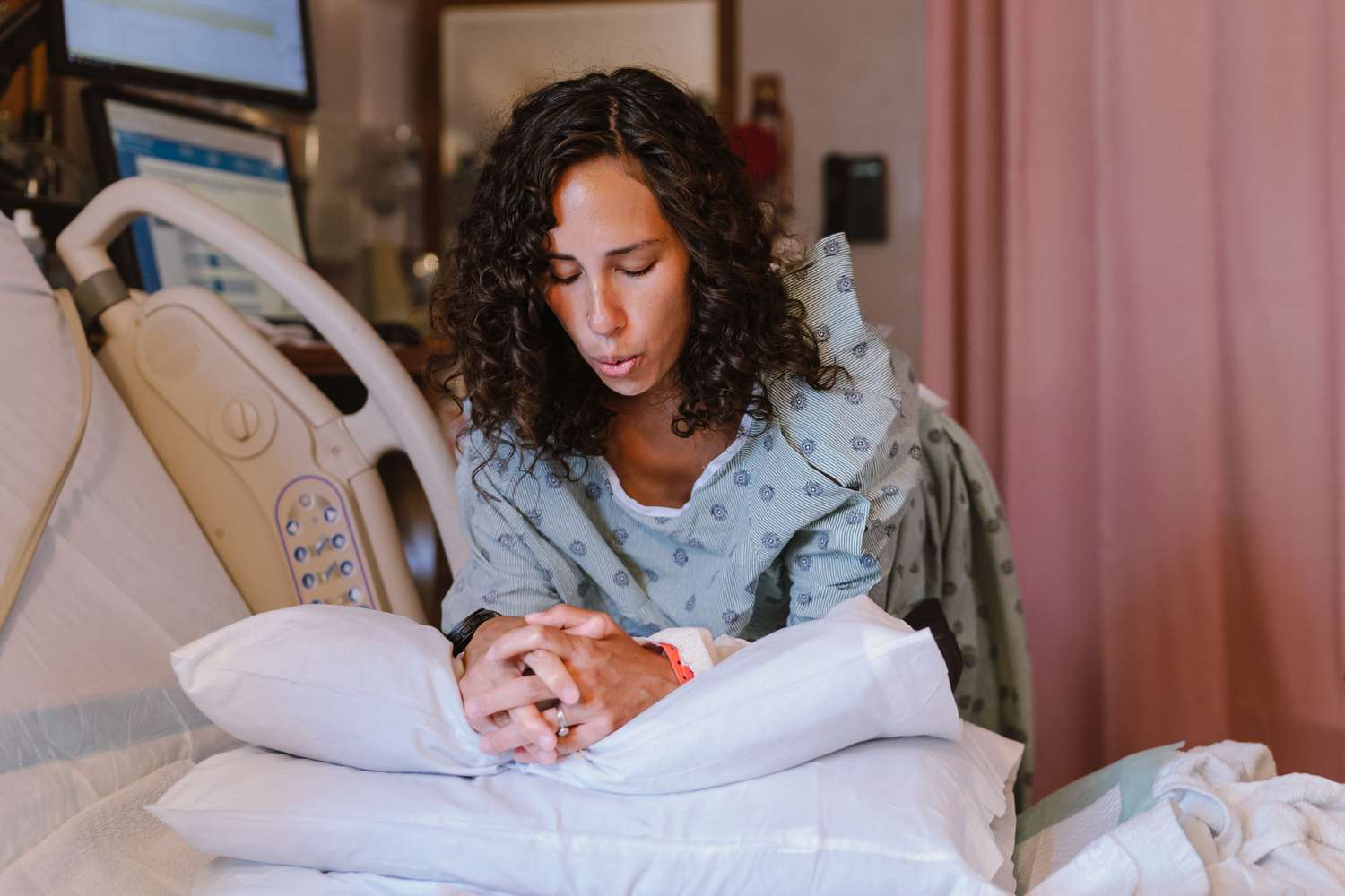 Pregnant woman doing breathing exercises during labor at the hospital