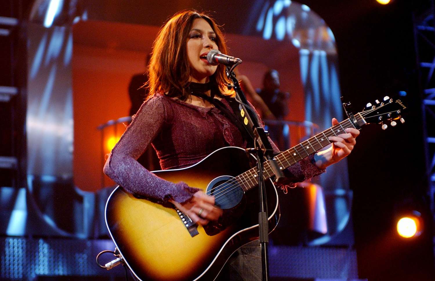 Michelle Branch performing at a concert while playing guitar