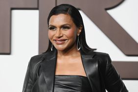 Mindy Kaling poses for a photo at a New York fashion show.