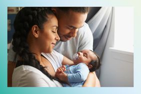 Couple cradling newborn baby.