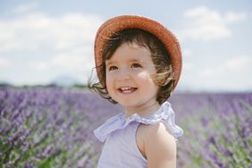 toddler wearing a hat in a lavender field