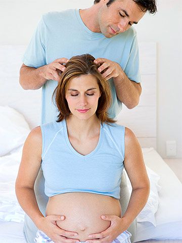 pregnant woman getting head massage