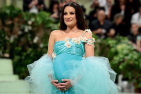 lea michele met gala gown holding her belly on the carpet