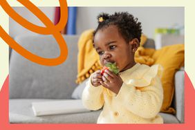 Black baby girl eating a strawberry