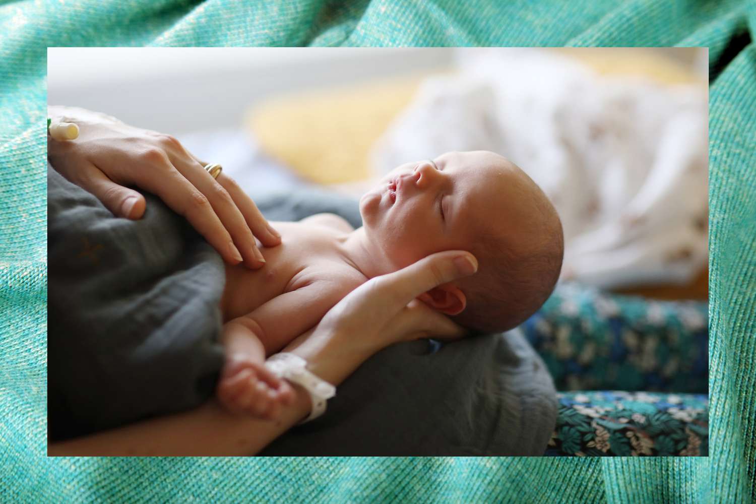 Birthing person holding a newborn baby.